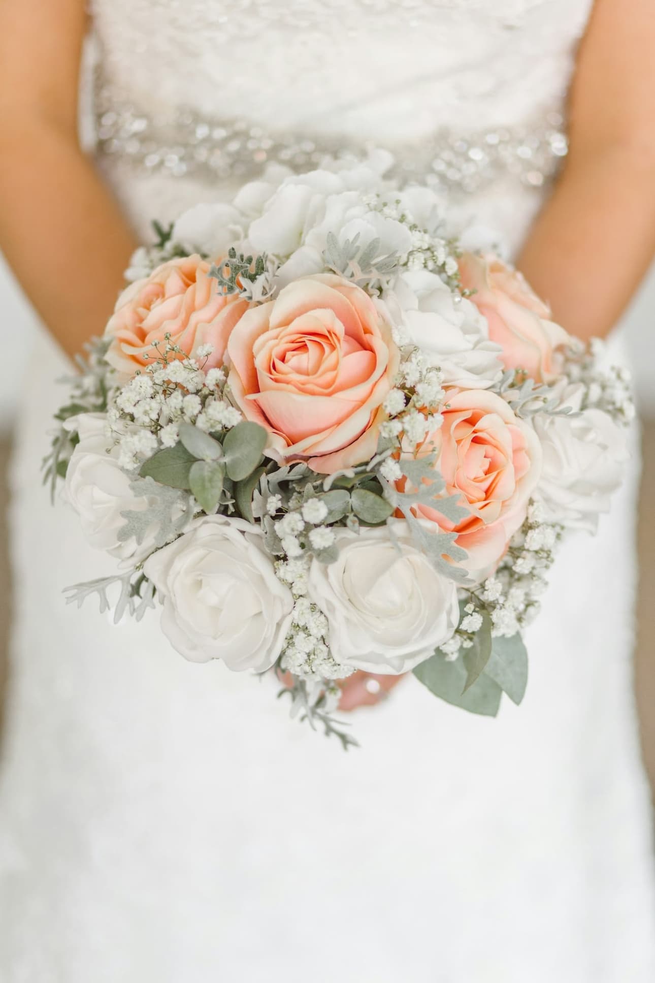 Bouquet of peach roses held close