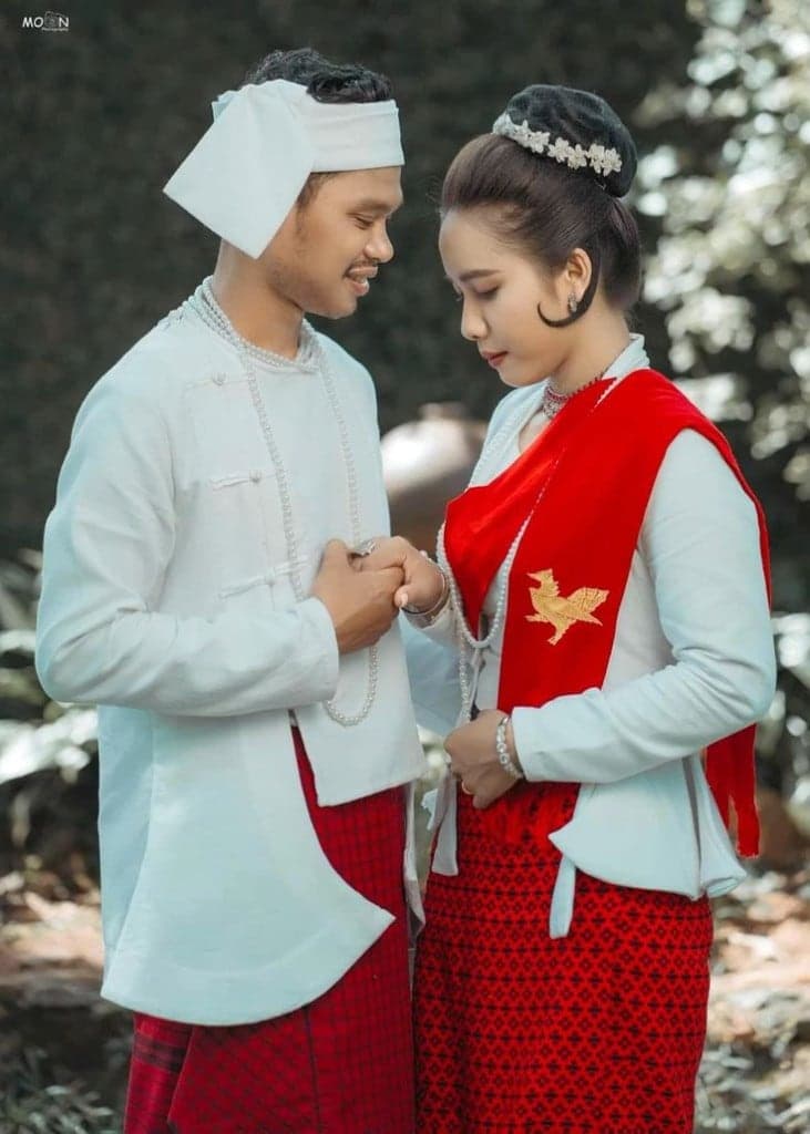 The couple in Mon traditional dress, the bride's red shawl embroidered with a golden Hintha
