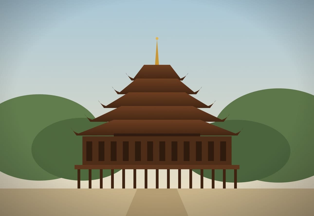 A teak monastery with tiered pyatthat roofs among trees